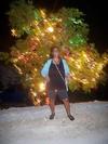 Tamika beside Ackee Christmas Tree